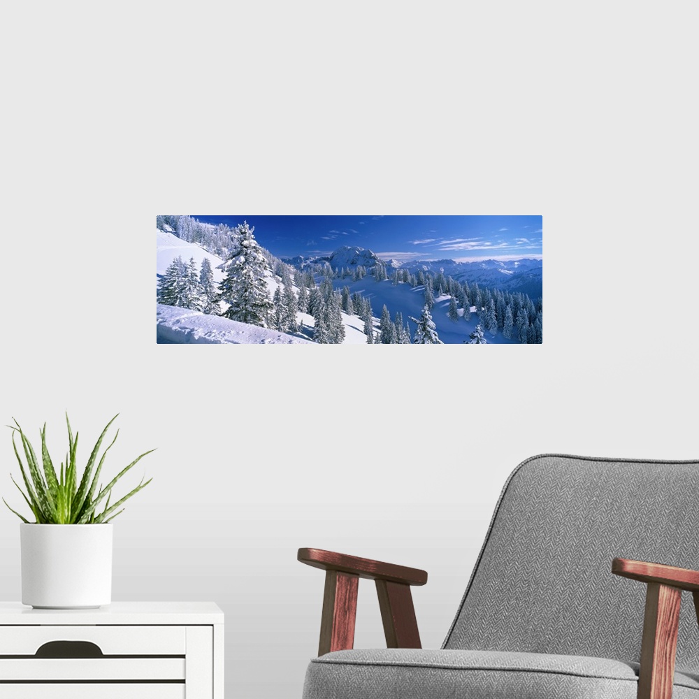 A modern room featuring This photograph is taken on the snow covered mountain of the downward slope that is covered with ...
