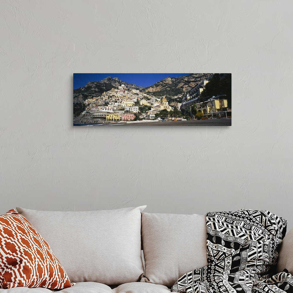 A bohemian room featuring View from below of the buildings stacked upon the hill off the Amalfi Coast in Positano, Italy.