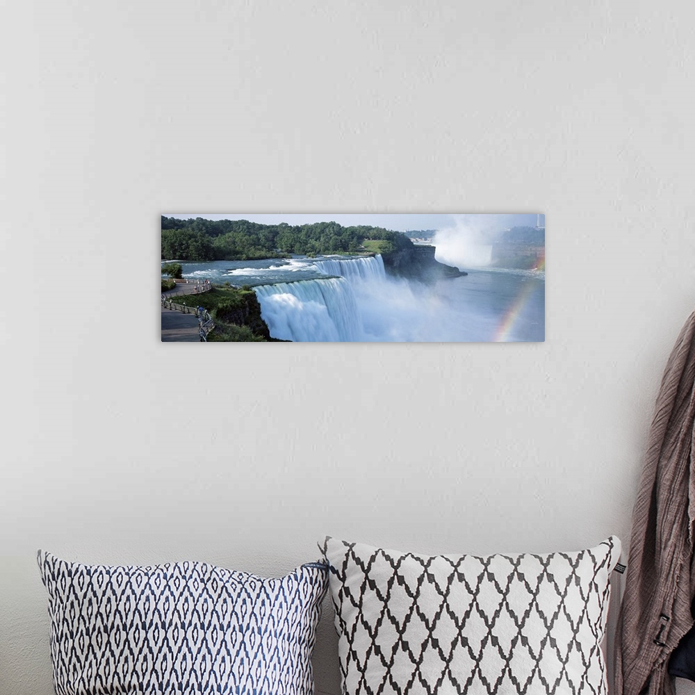 A bohemian room featuring An elongated view of Niagara Falls with a sliver of a rainbow just to the right of the falls.