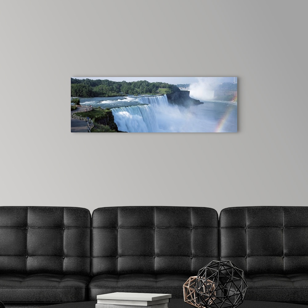 A modern room featuring An elongated view of Niagara Falls with a sliver of a rainbow just to the right of the falls.