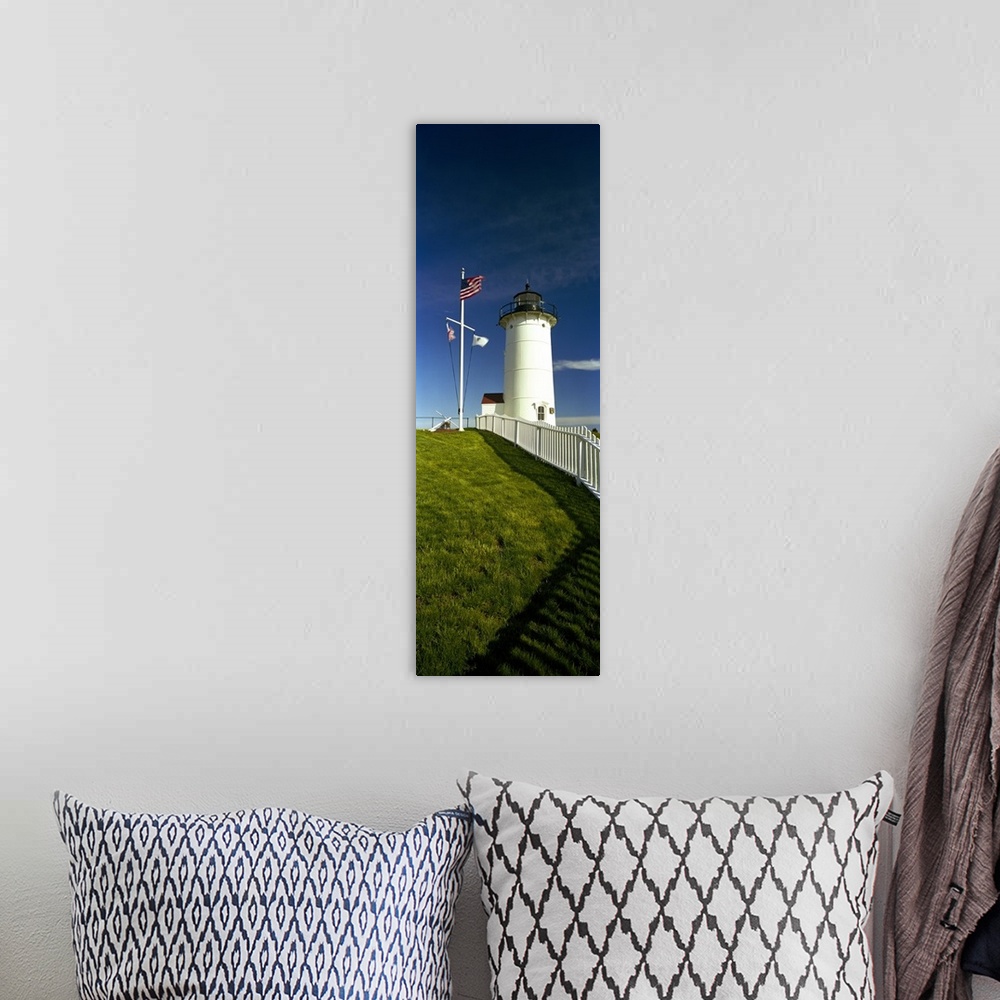 A bohemian room featuring Giant vertical photograph looking up a grassy hill along a fence toward Nobska Lighthouse next to...