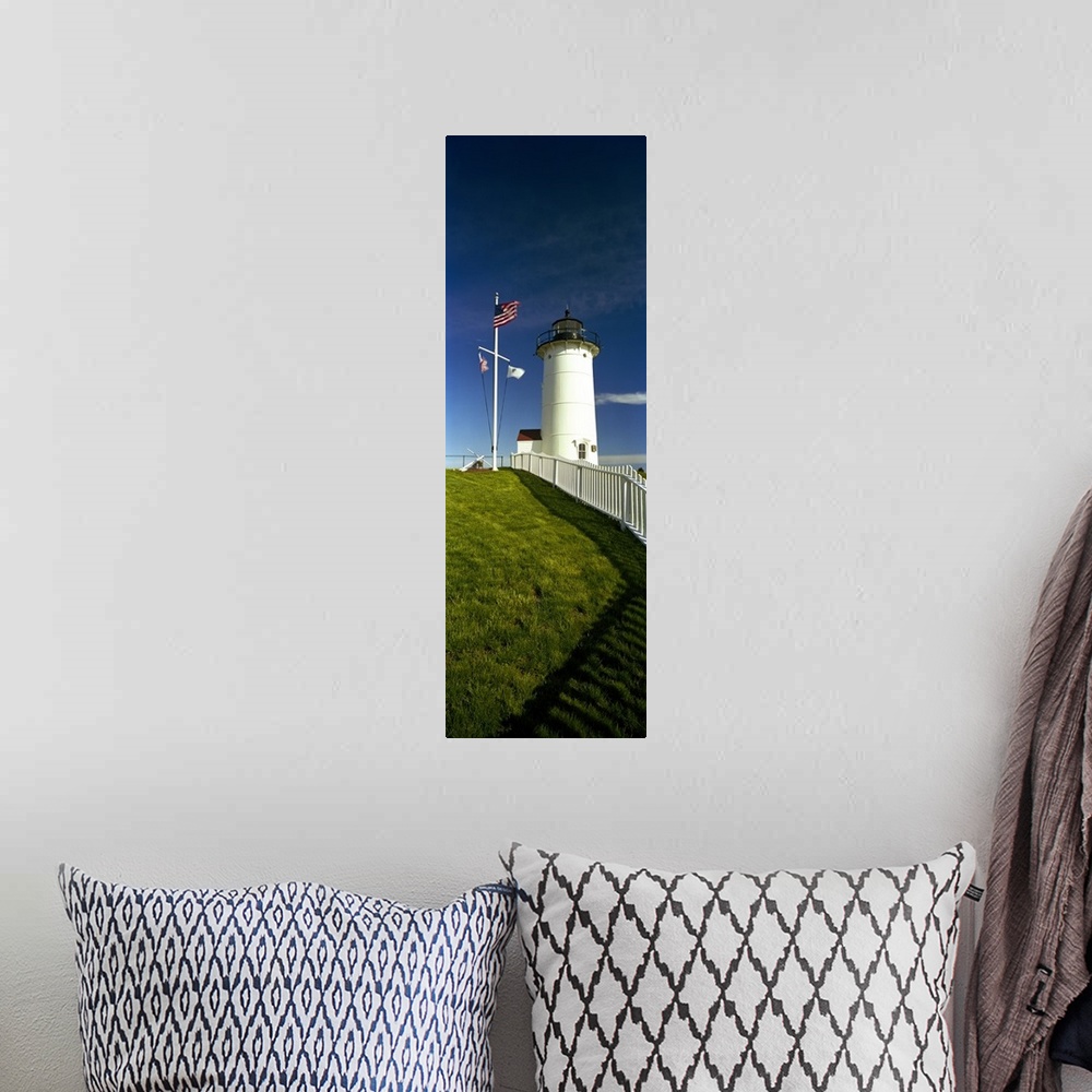 A bohemian room featuring Giant vertical photograph looking up a grassy hill along a fence toward Nobska Lighthouse next to...