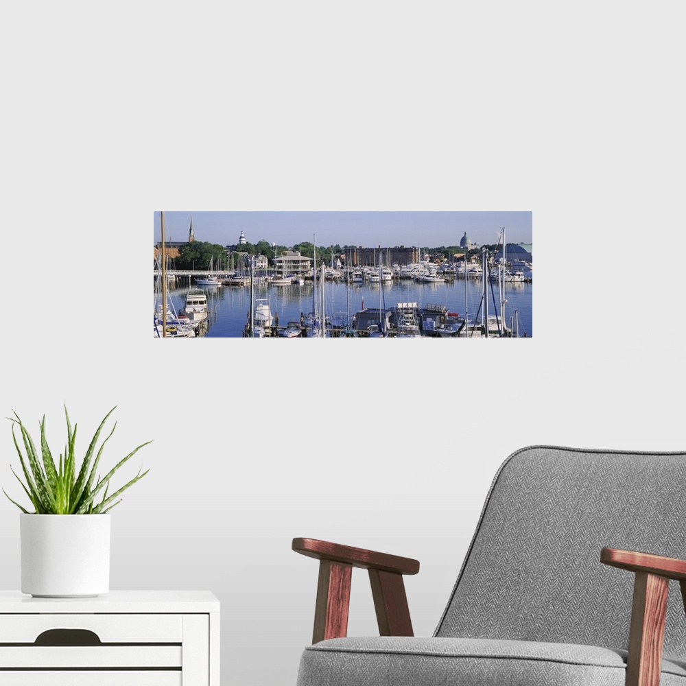A modern room featuring Panoramic photograph of harbor filled with boats with trees in the distance under a clear sky.