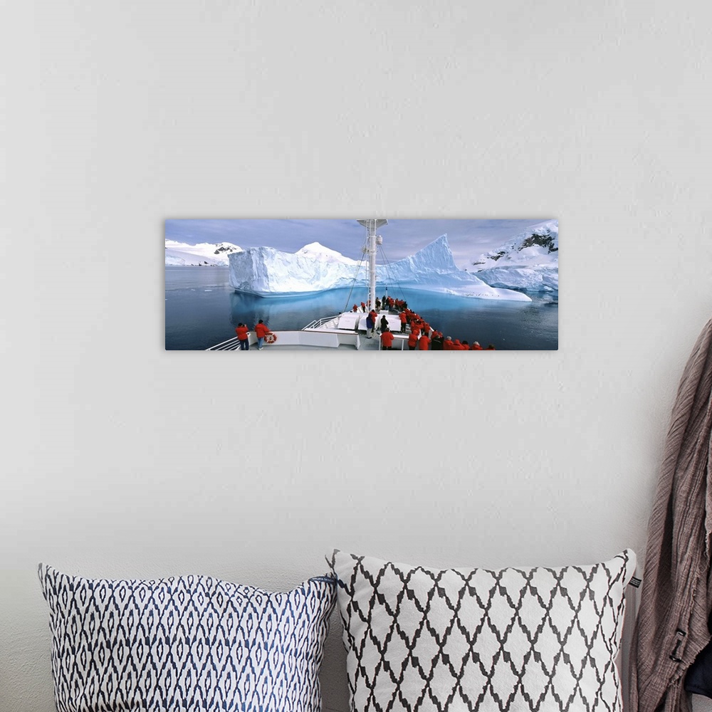 A bohemian room featuring Antarctica, Antarctic Peninsula, Tourists standing on a cruise ship watching at iceberg