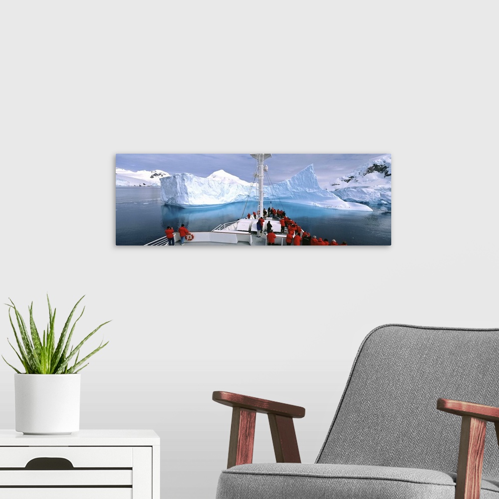 A modern room featuring Antarctica, Antarctic Peninsula, Tourists standing on a cruise ship watching at iceberg
