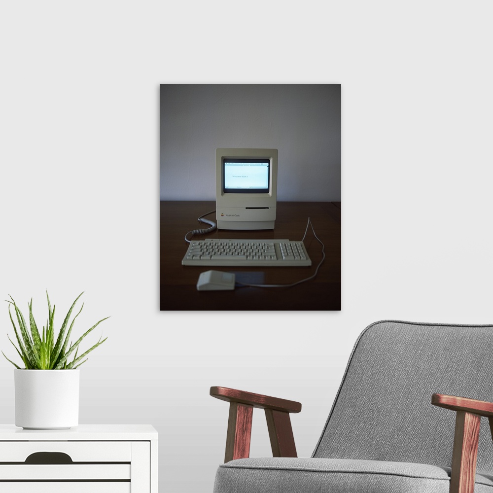 A modern room featuring Apple Macintosh Classic desktop PC