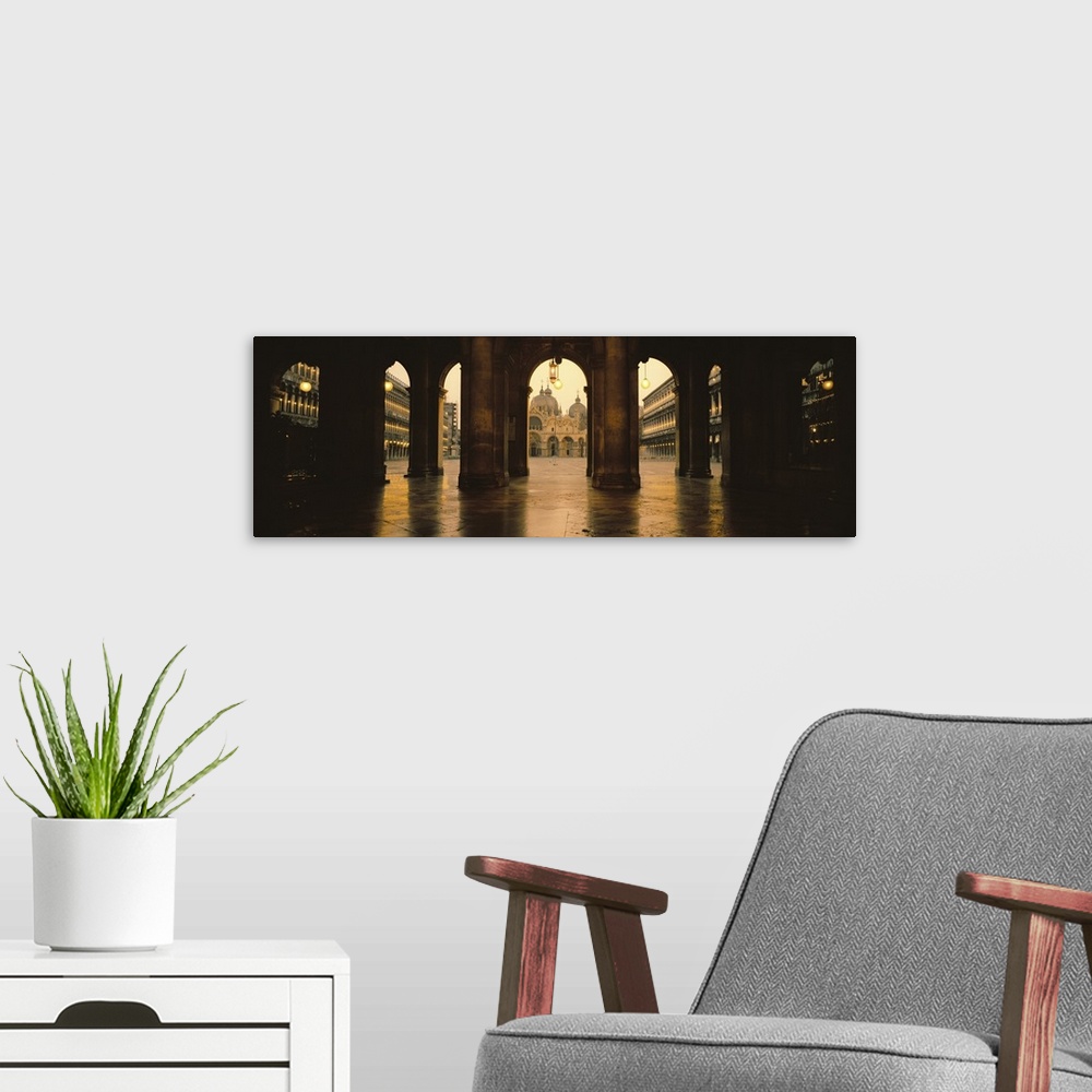 A modern room featuring Panoramic photograph taken of St. Marks Square in Venice looking through stone arches and into th...