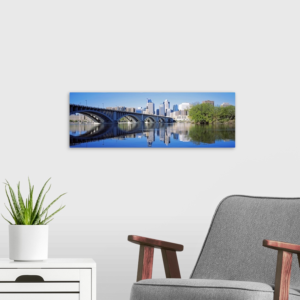 A modern room featuring Big panoramic photo of a bridge spanning across a river in Minneanapolis, Minnesota (MN) on a sun...
