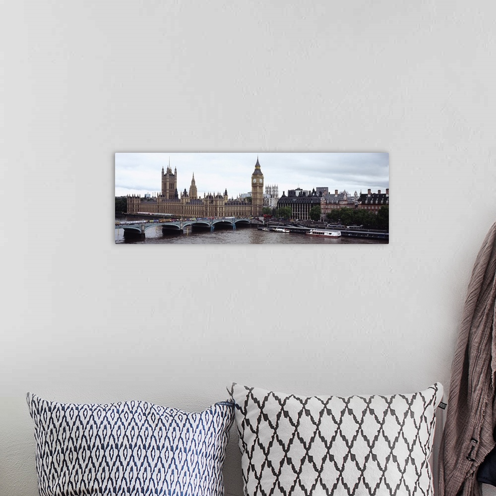 A bohemian room featuring Panoramic photo of a bridge leading into the city with boats in the river Thames, under a skyline...