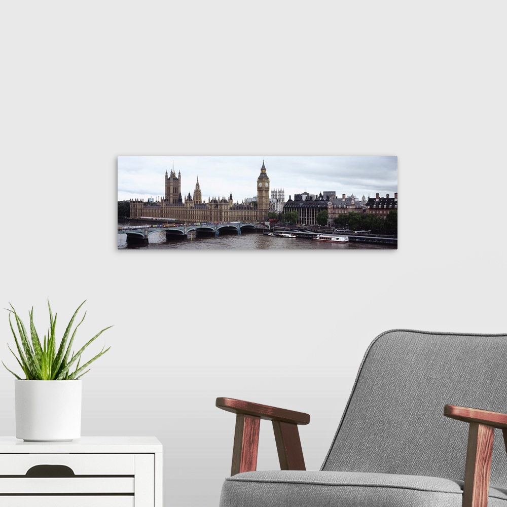 A modern room featuring Panoramic photo of a bridge leading into the city with boats in the river Thames, under a skyline...