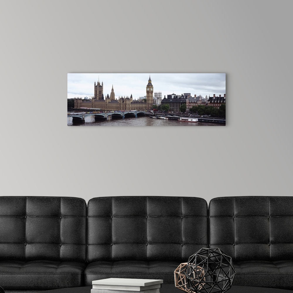 A modern room featuring Panoramic photo of a bridge leading into the city with boats in the river Thames, under a skyline...