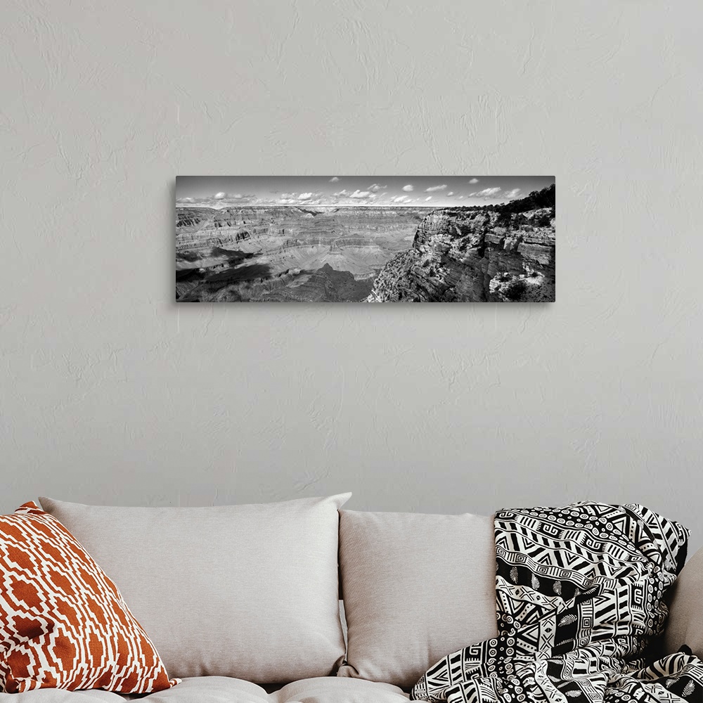 A bohemian room featuring Panoramic photo on canvas of a view of the Grand Canyon seen from the top of a cliff with puffy c...