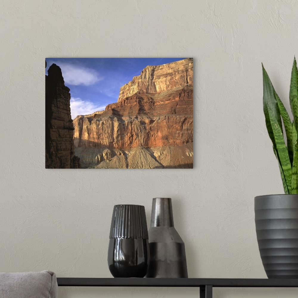 A modern room featuring Large, close up photograph of the side of  a mountain beneath a blue sky in the Grand Canyon Nati...