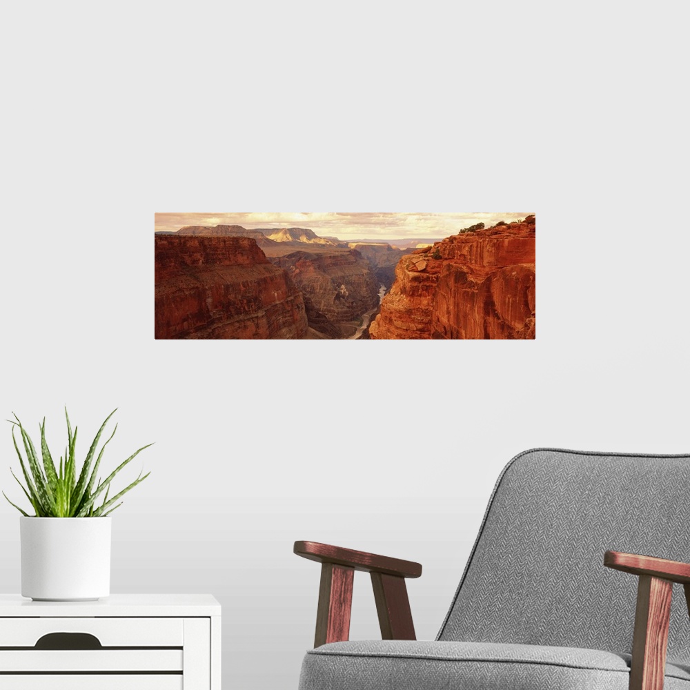 A modern room featuring Panoramic, landscape photograph of the Grand Canyon beneath a golden sky, in Arizona, at Toroweap...