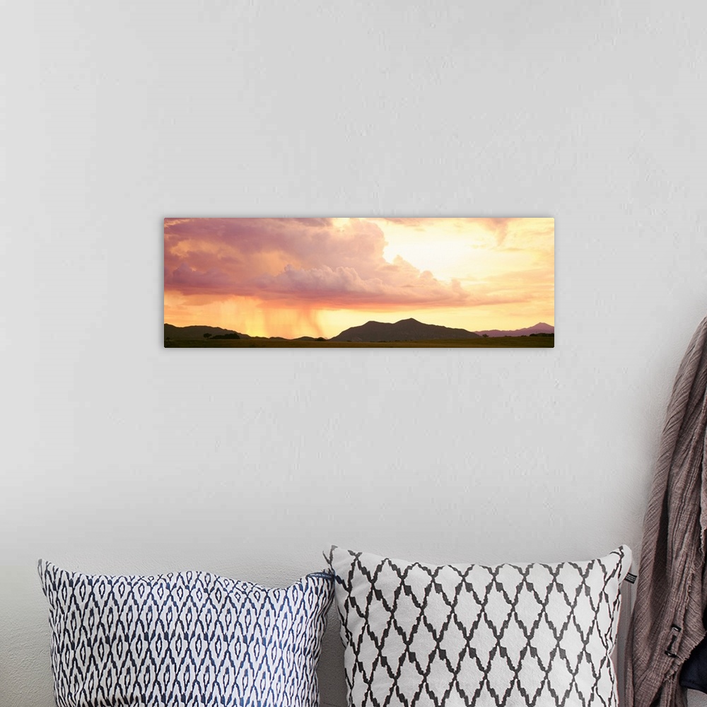 A bohemian room featuring Arizona, Huachuca Mountains, San Rafael Valley, rain storm at sunset