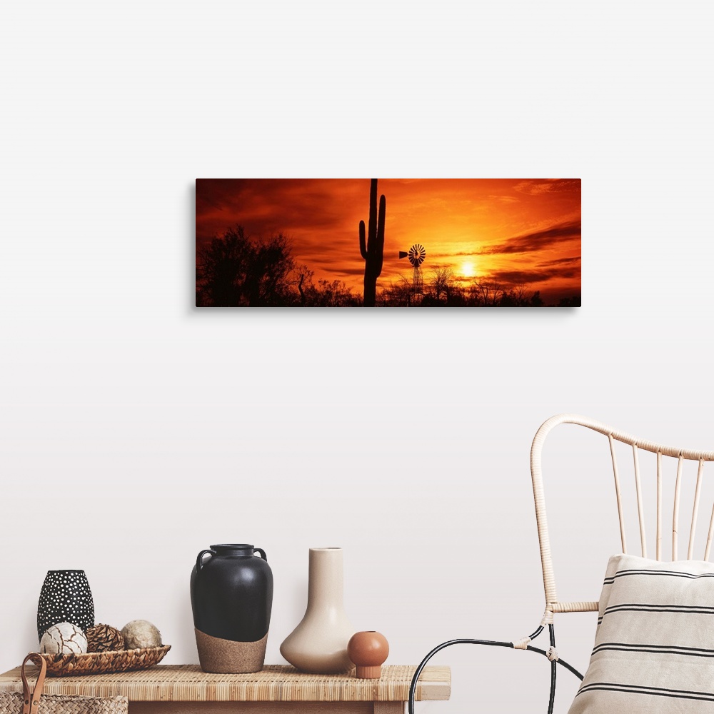A farmhouse room featuring Panoramic photograph displays the sun heading towards the horizon and spreading its remaining lig...