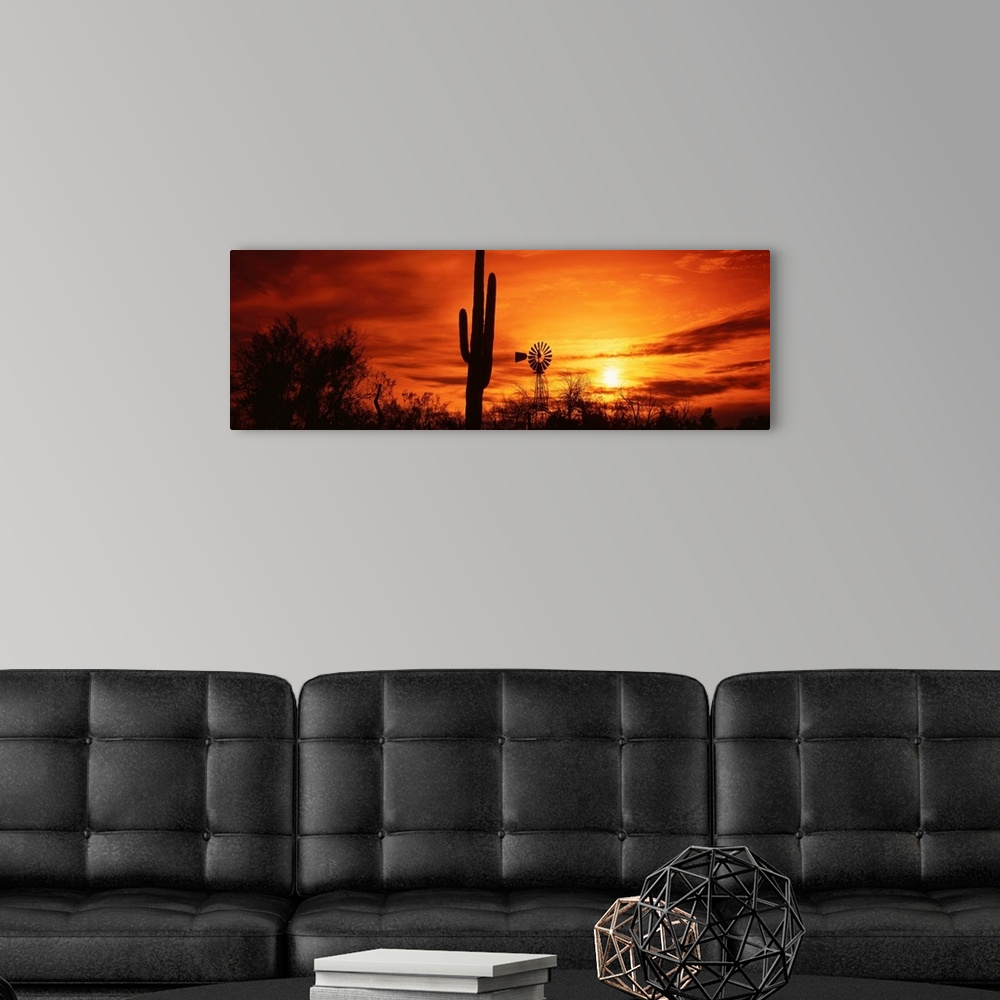 A modern room featuring Panoramic photograph displays the sun heading towards the horizon and spreading its remaining lig...