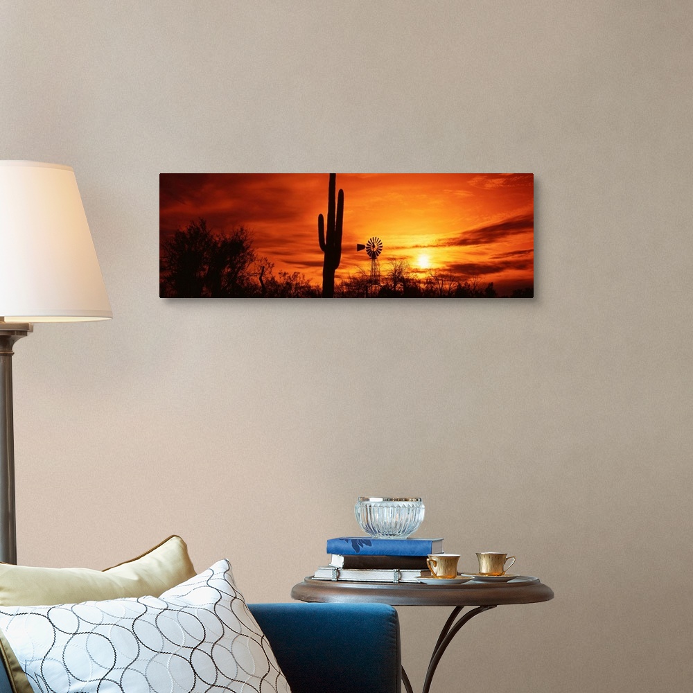 A traditional room featuring Panoramic photograph displays the sun heading towards the horizon and spreading its remaining lig...