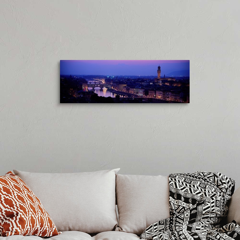 A bohemian room featuring Panoramic photograph of skyline at night with buildings lit up.
