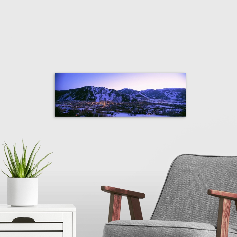 A modern room featuring Long panoramic photo of Aspen Colorado at dust nestled in the valley of the snow covered mountains.
