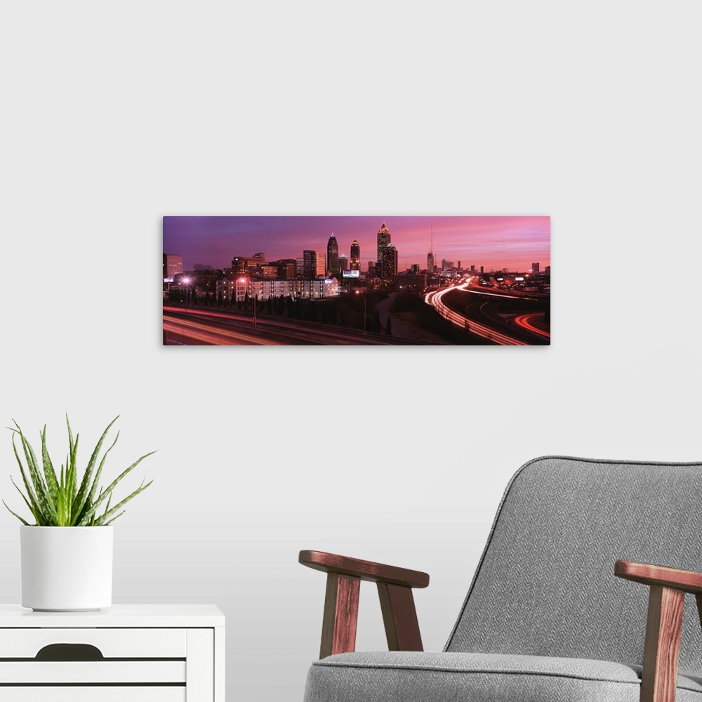 A modern room featuring Night panaramic of Atlanta, George skyscrapers with highways running to downtown.