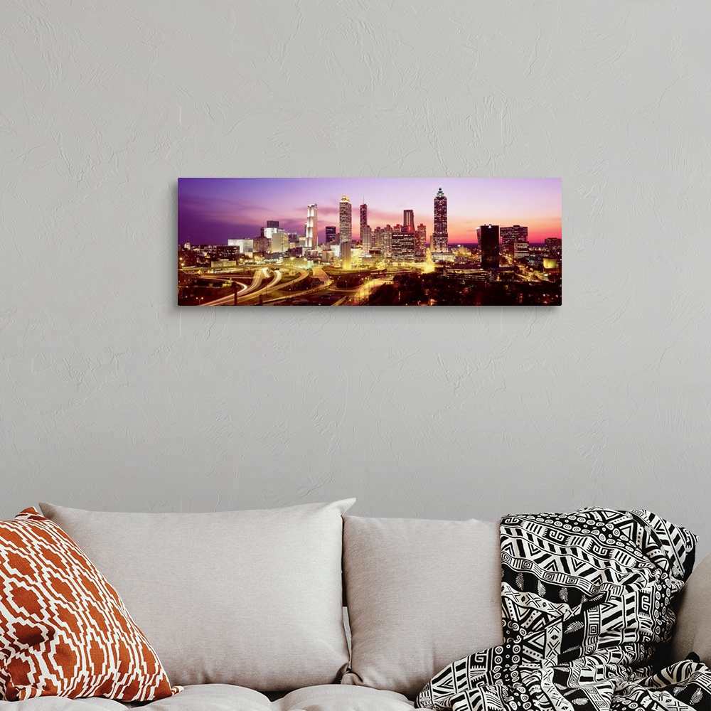 A bohemian room featuring Skyline of Atlanta, GA with buildings lit up.