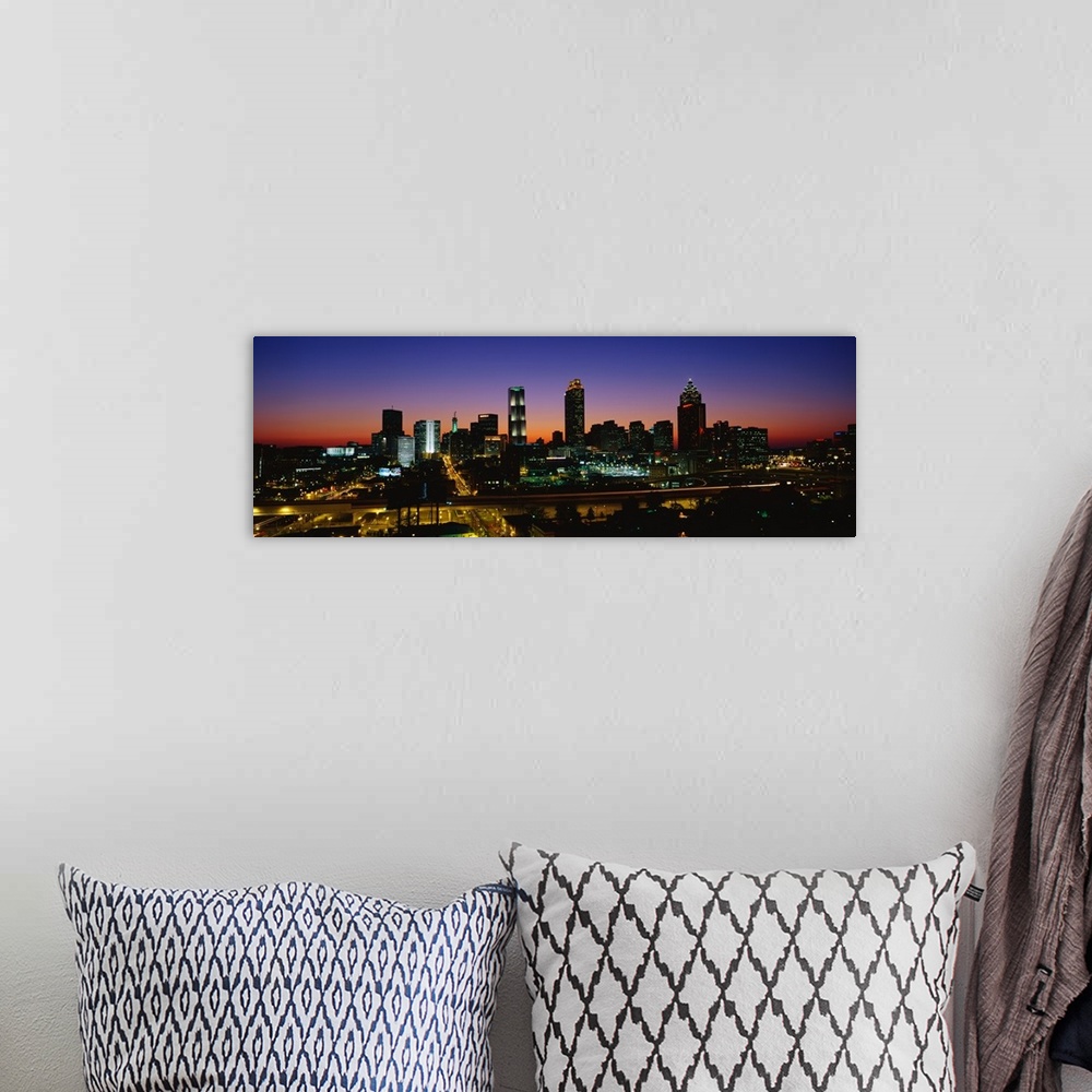 A bohemian room featuring Panoramic photograph at nighttime shows an aerial view overlooking the illuminated skyline and bu...