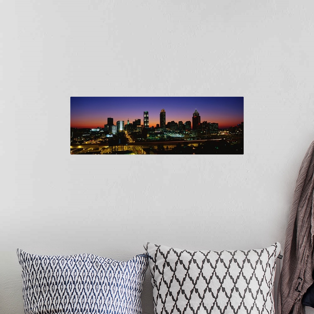 A bohemian room featuring Panoramic photograph at nighttime shows an aerial view overlooking the illuminated skyline and bu...