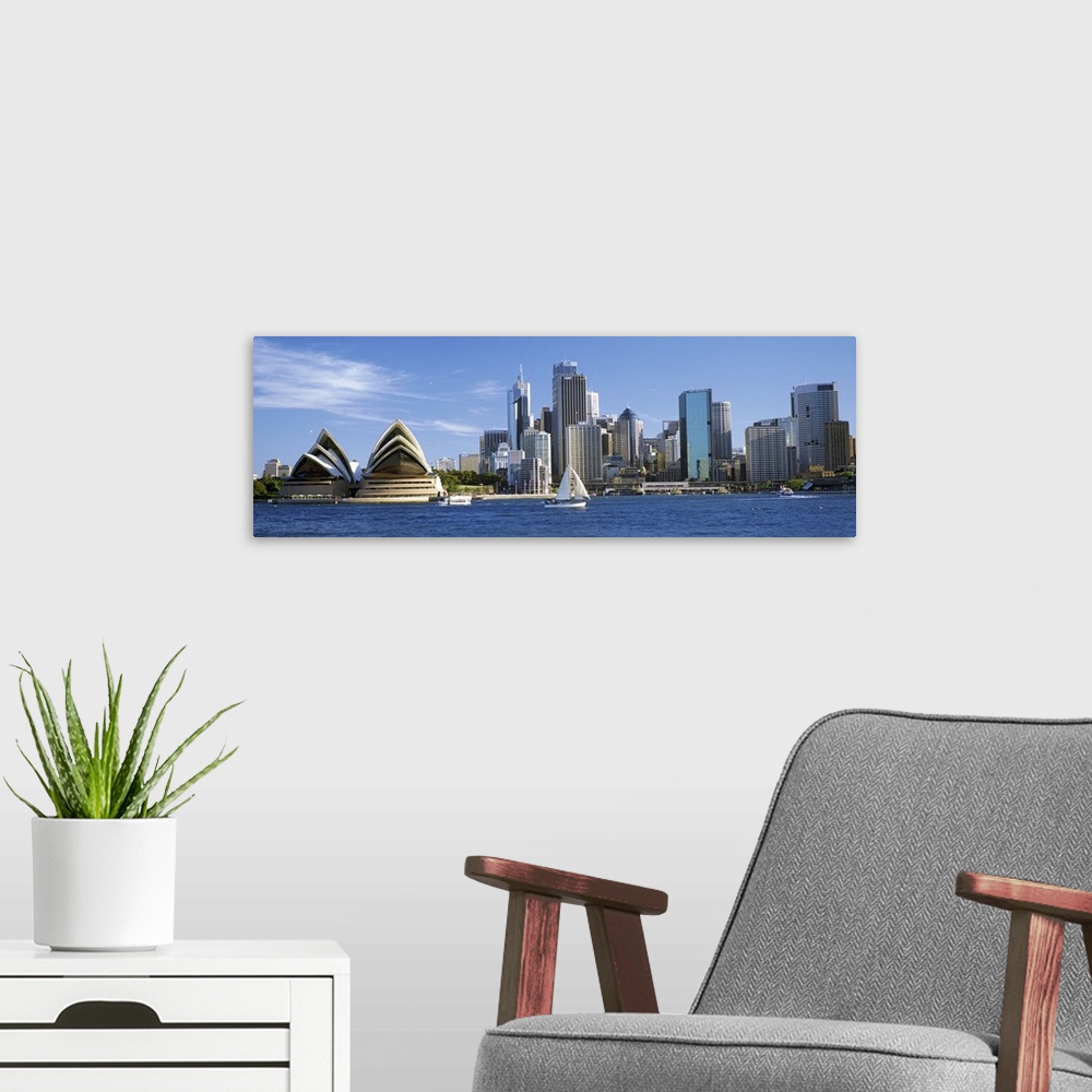 A modern room featuring Sydney skyline panorama, including the Opera House and harbor.