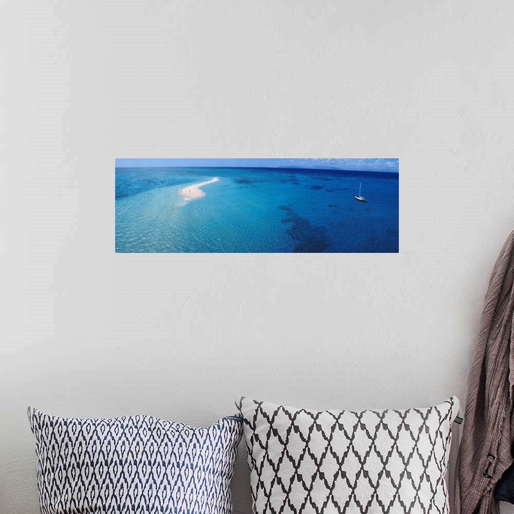 A bohemian room featuring Panoramic, aerial photograph of clear blue waters over the Great Barrier Reef, a single sailboat ...