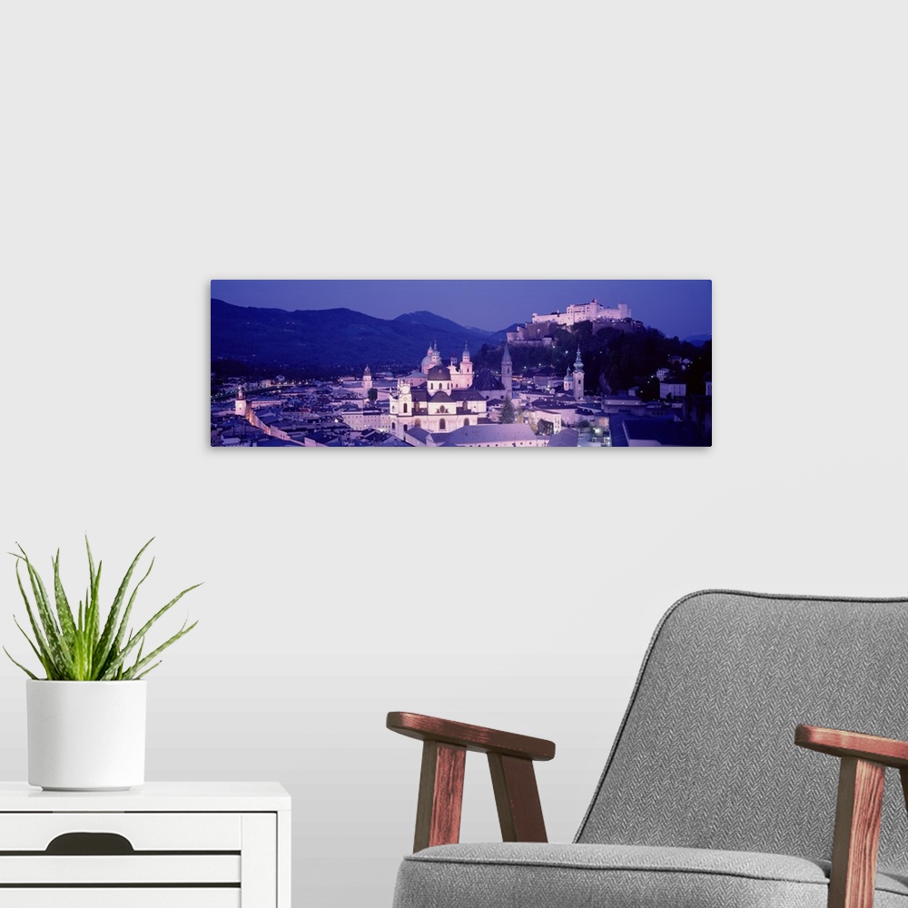 A modern room featuring Austria, Salzburg, Panoramic view of the city in dusk