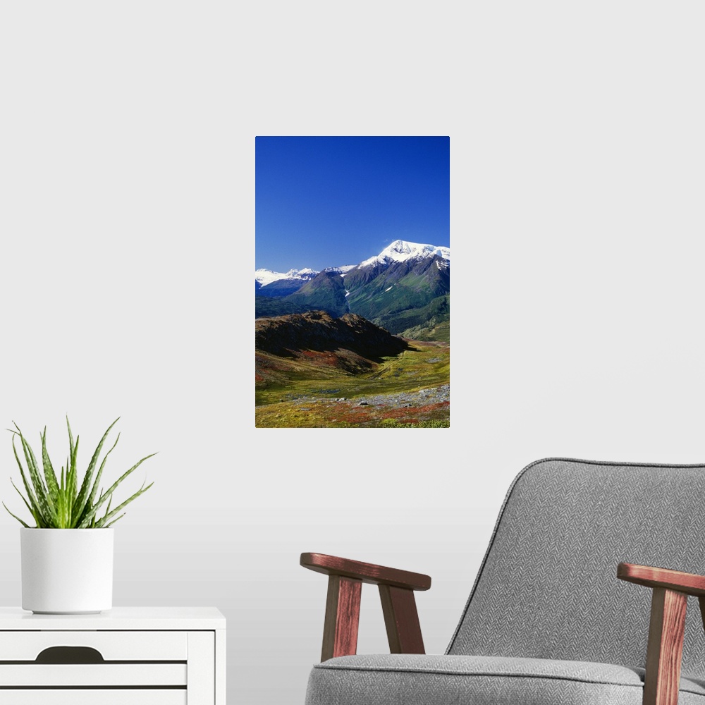 A modern room featuring Autumn color tundra, snow-capped mountains, Alaska