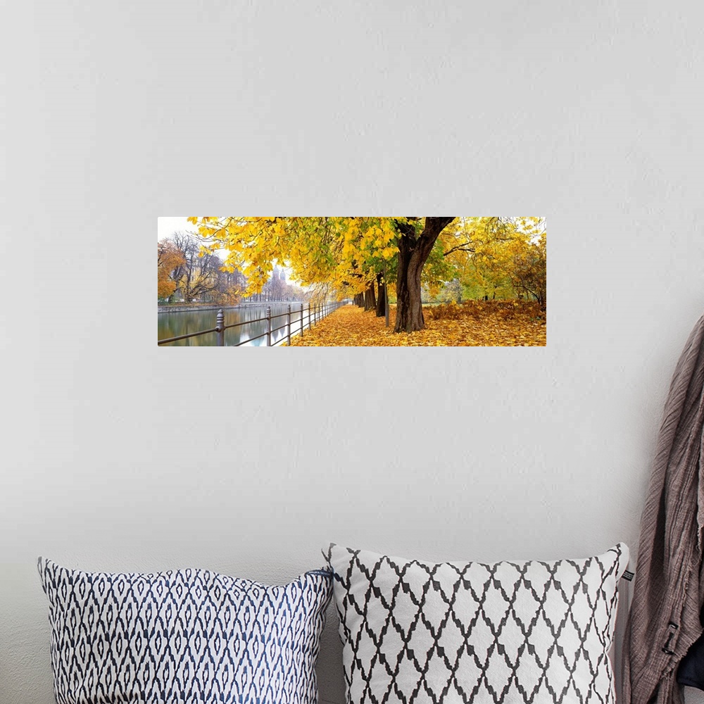 A bohemian room featuring Large panoramic photograph of city riverbank in Munich, Germany as fall/autumn turns to winter an...