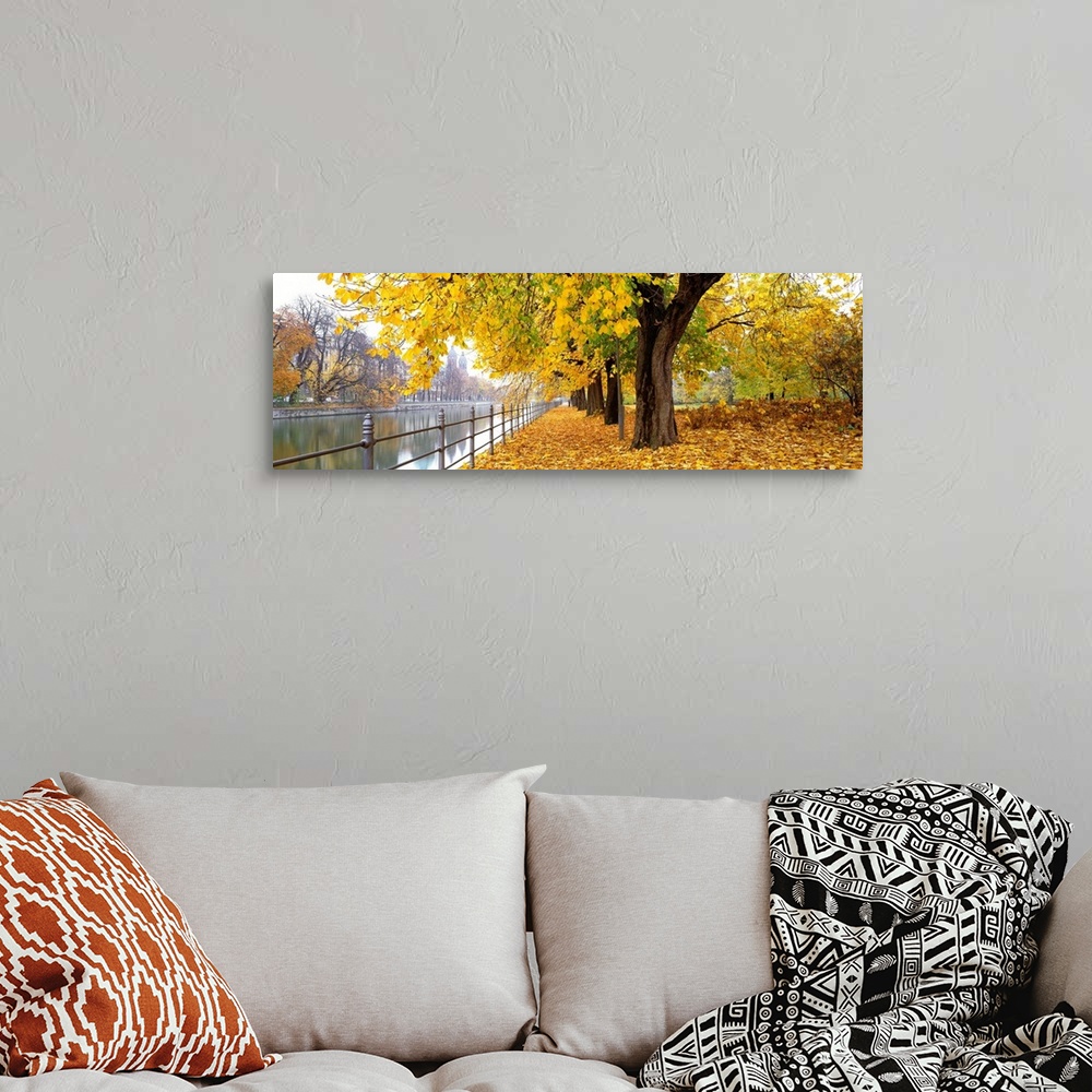 A bohemian room featuring Large panoramic photograph of city riverbank in Munich, Germany as fall/autumn turns to winter an...