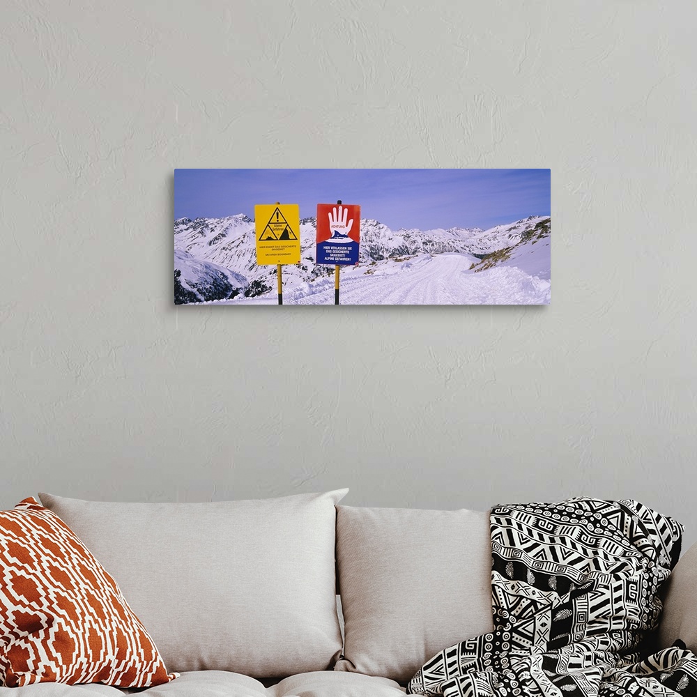 A bohemian room featuring Avalanche warning signs on snowcapped mountains, Rendl Ski Area, St. Anton, Austria