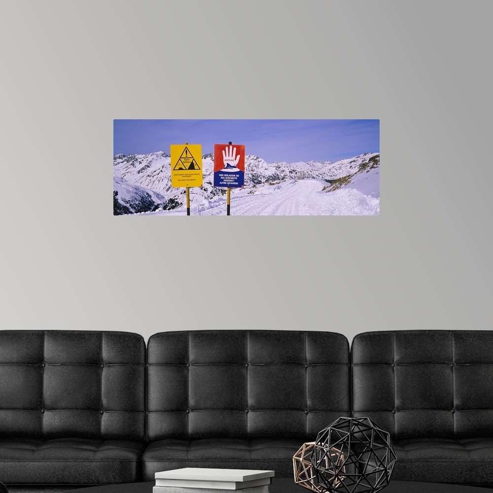 A modern room featuring Avalanche warning signs on snowcapped mountains, Rendl Ski Area, St. Anton, Austria