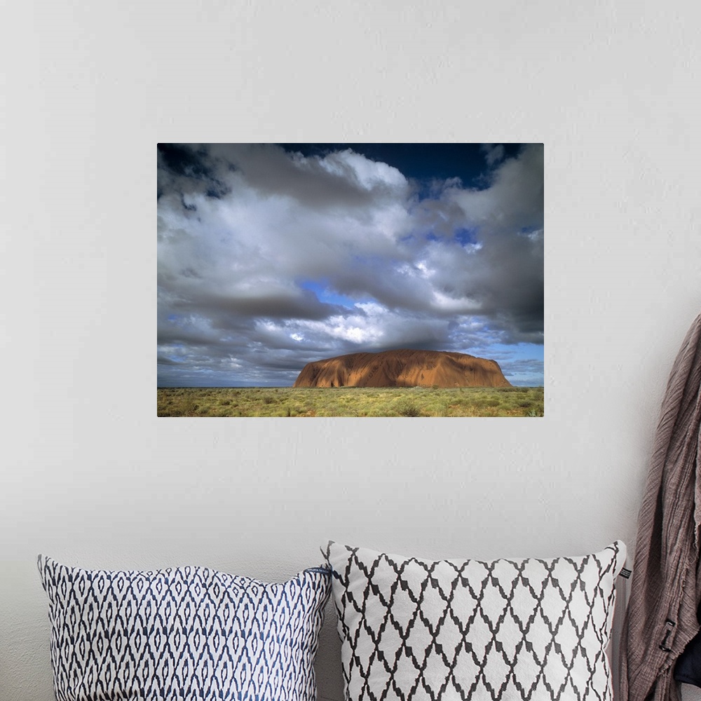 A bohemian room featuring This is a landscape photograph of the mountain island landmark in the outback under growing cloud...