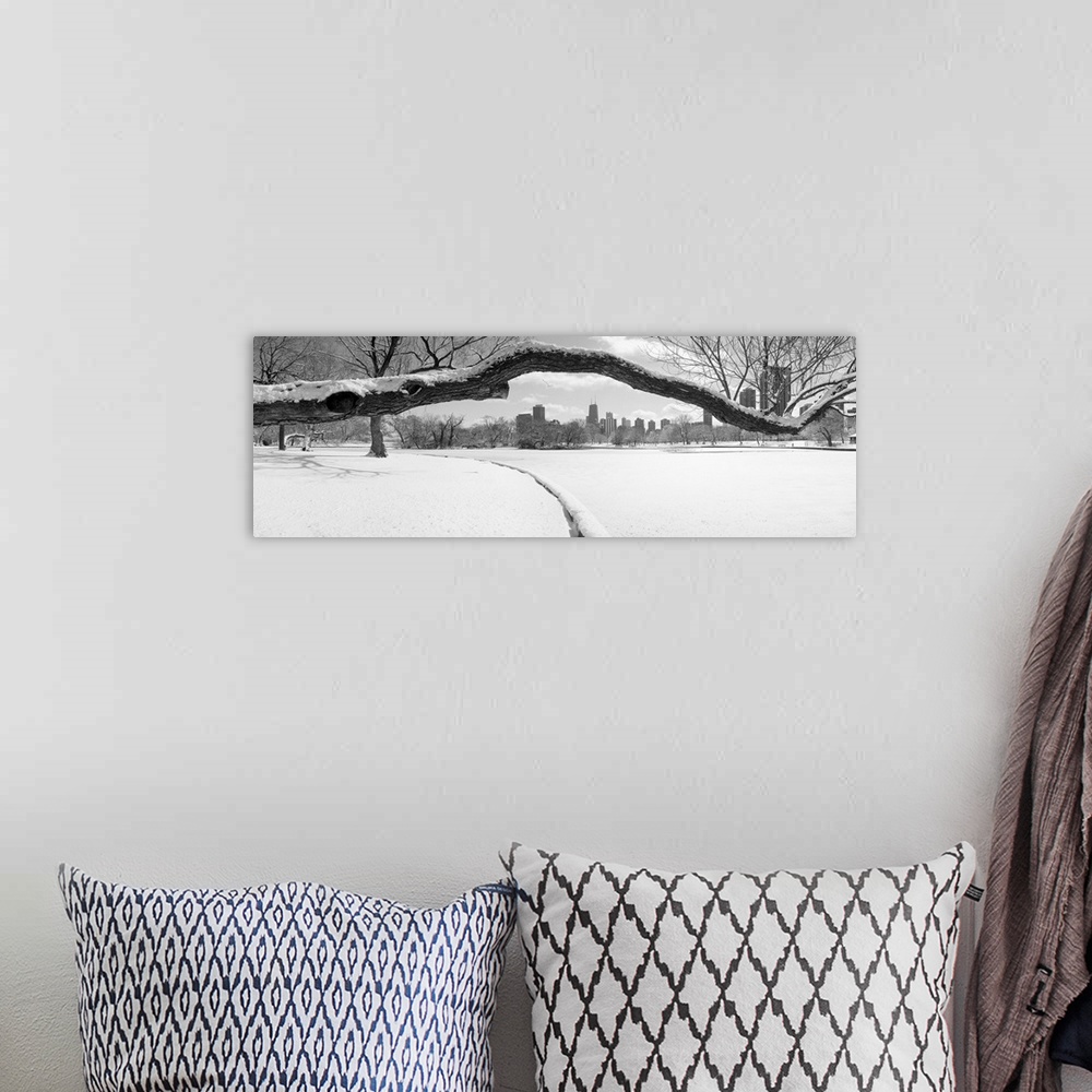 A bohemian room featuring Large panoramic photograph of a snow covered tree branch close up with snow on the ground and the...