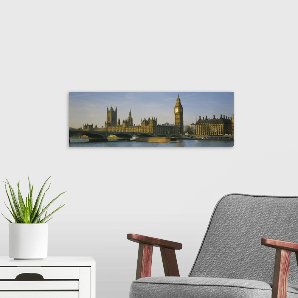 A modern room featuring Panoramic photograph of the London skyline, including Big Ben.  In the foreground, a barge in the...