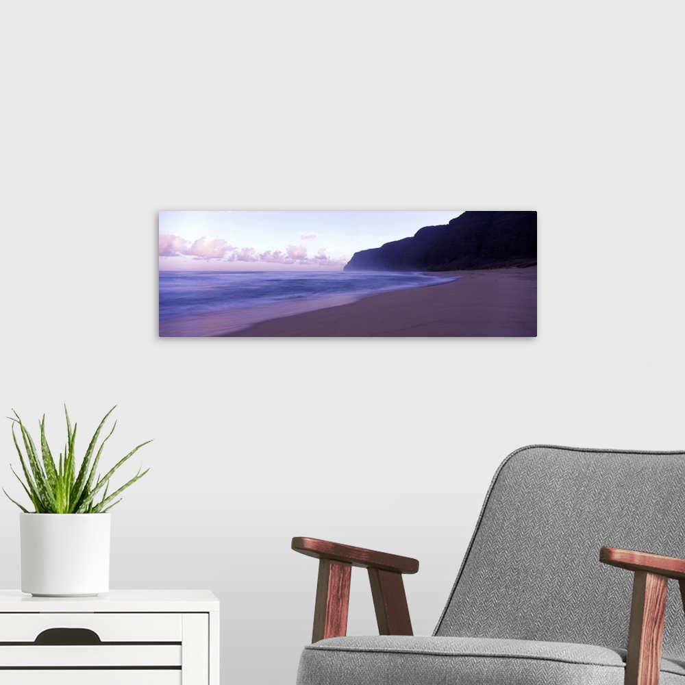 A modern room featuring Serene panoramic photograph of a Hawaii beach at dusk in soft cooler tones.