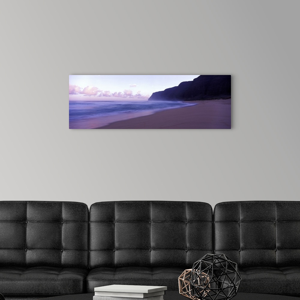 A modern room featuring Serene panoramic photograph of a Hawaii beach at dusk in soft cooler tones.