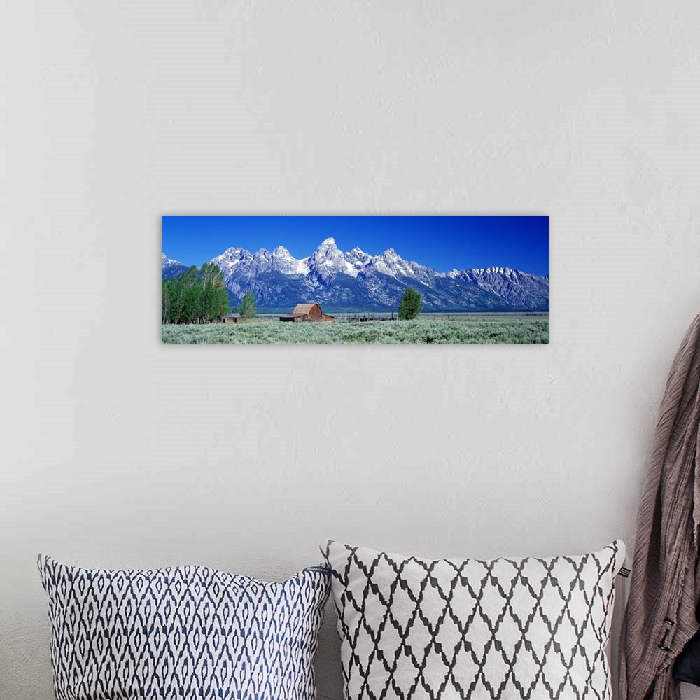A bohemian room featuring Horizontal, large, panoramic photograph of a barn in a vast field in front of the Tetons in Grand...