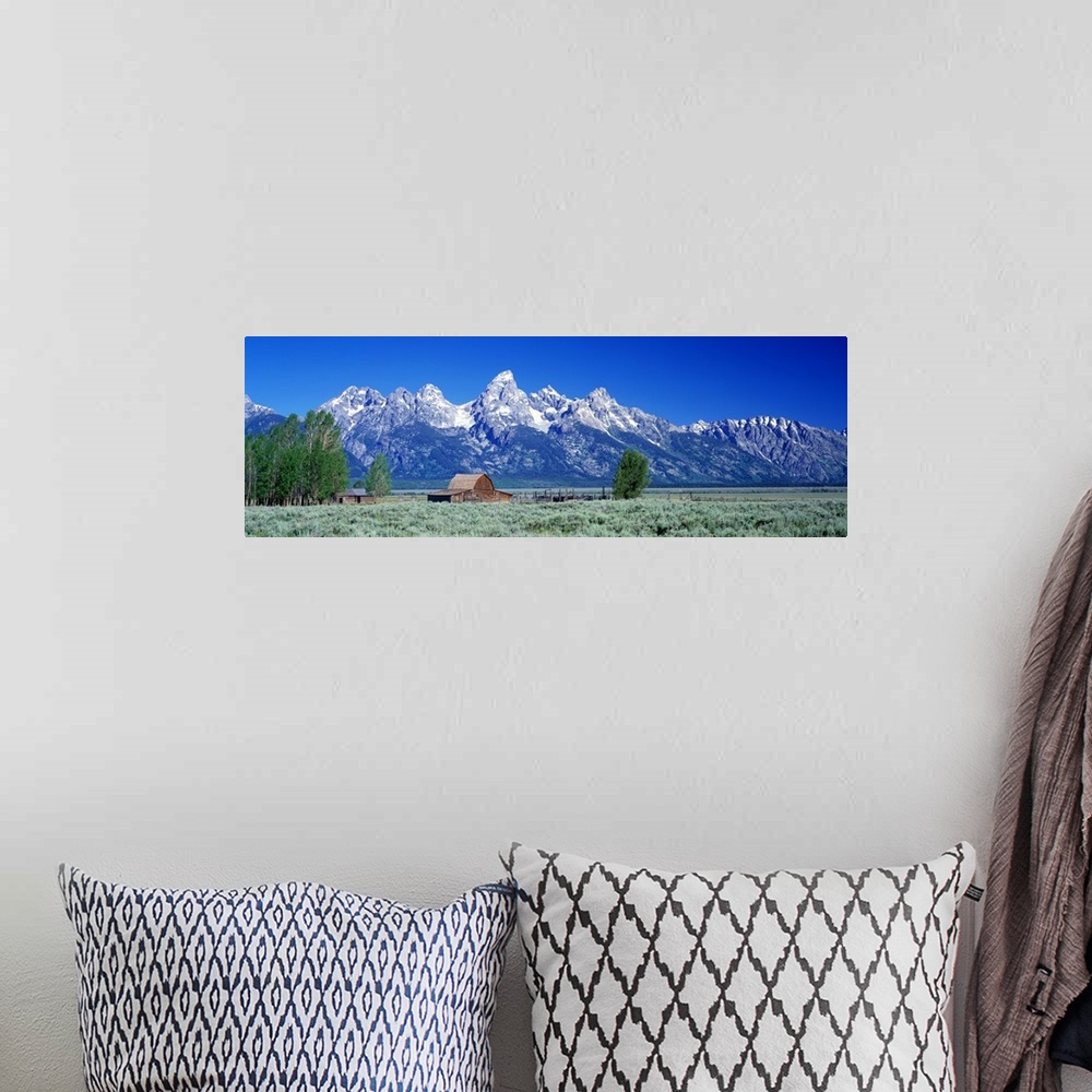A bohemian room featuring Horizontal, large, panoramic photograph of a barn in a vast field in front of the Tetons in Grand...