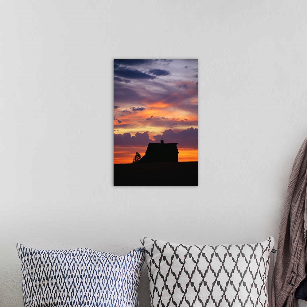 A bohemian room featuring Vertical panoramic photograph of farm house silhouette at dusk under a cloudy and colorful sky.