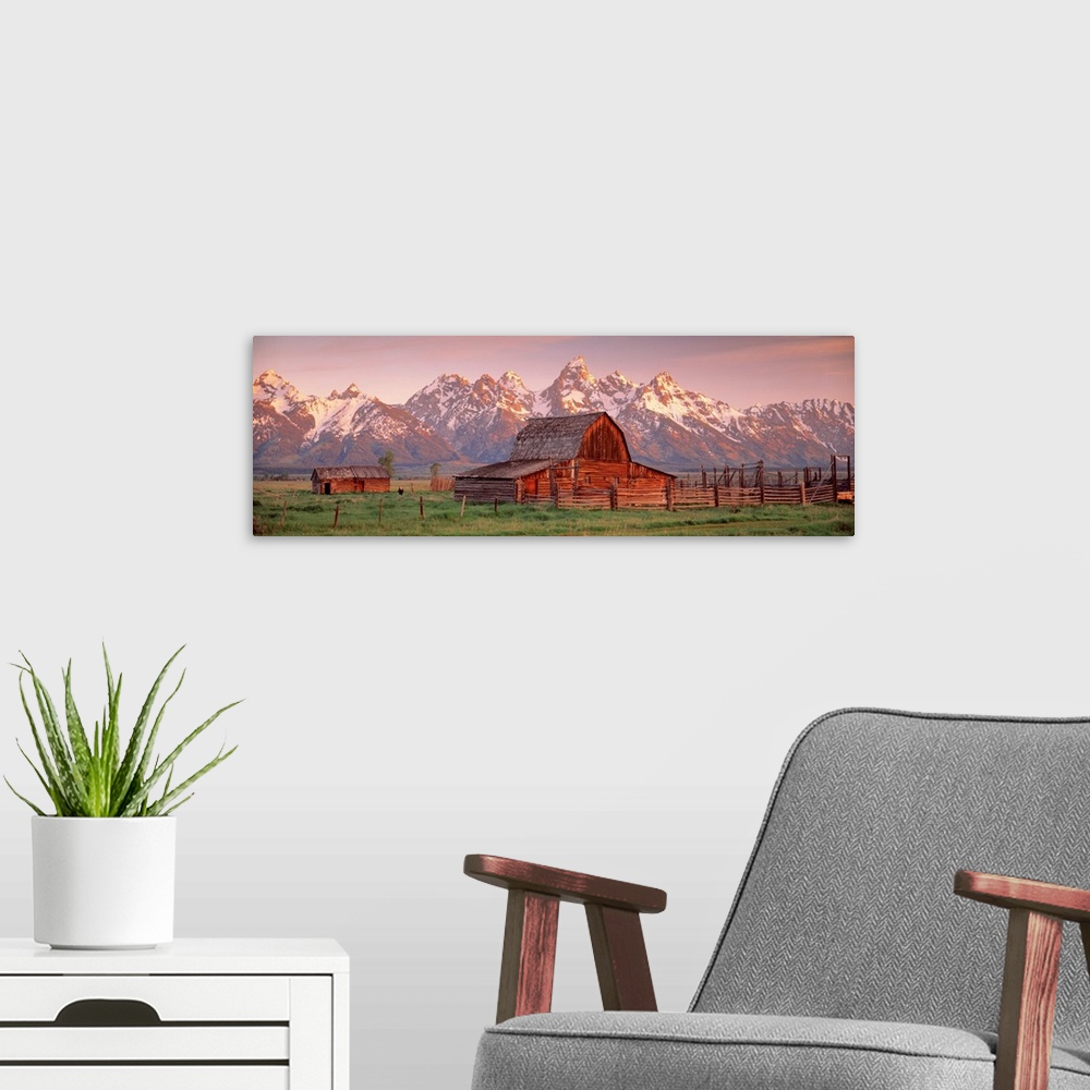 A modern room featuring Panoramic photograph of a large barn on a farm in Grand Teton National Park in Wyoming. Located i...