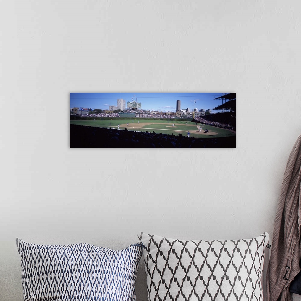 A bohemian room featuring Panoramic photo print of a professional baseball field with a game being played surrounded by spe...
