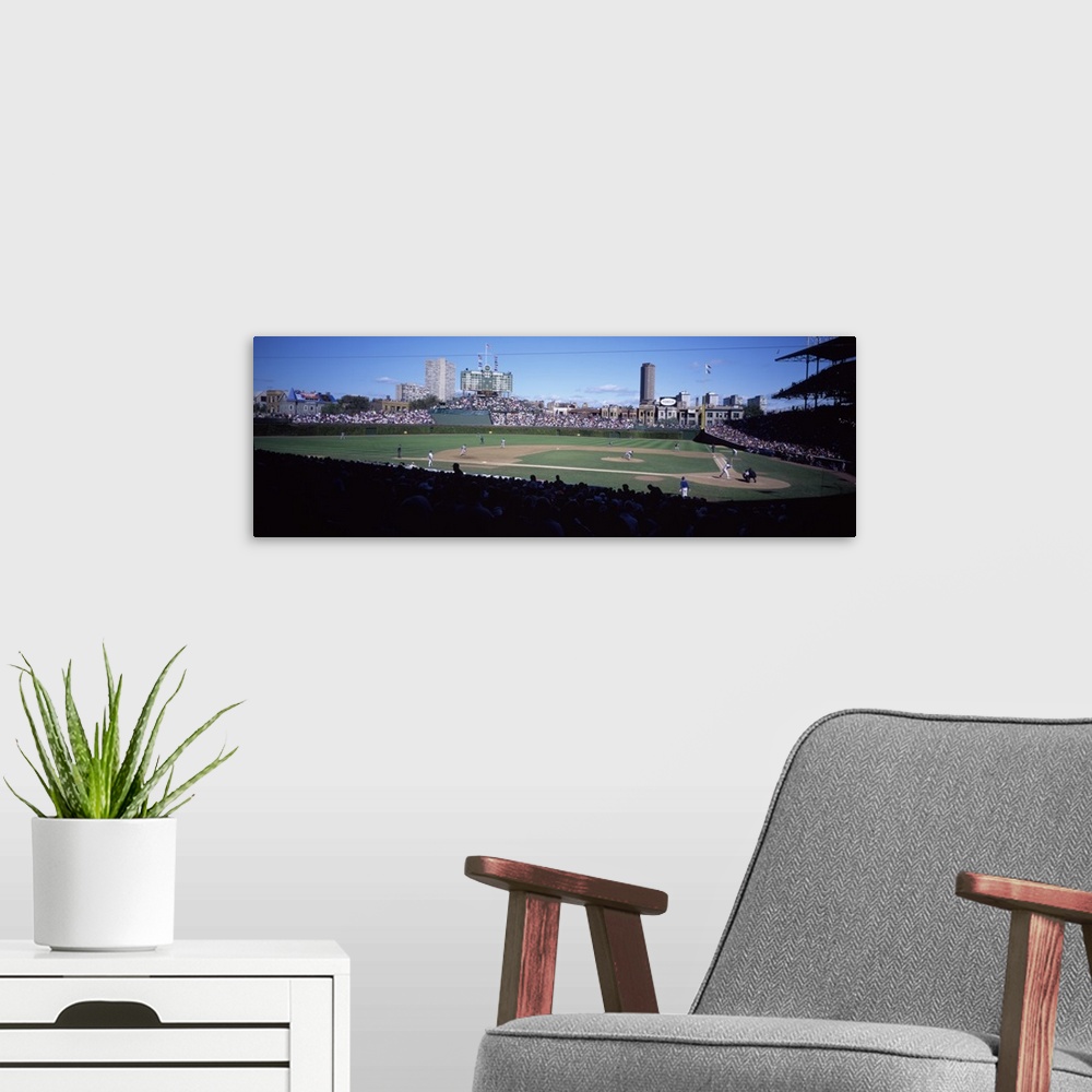 A modern room featuring Panoramic photo print of a professional baseball field with a game being played surrounded by spe...