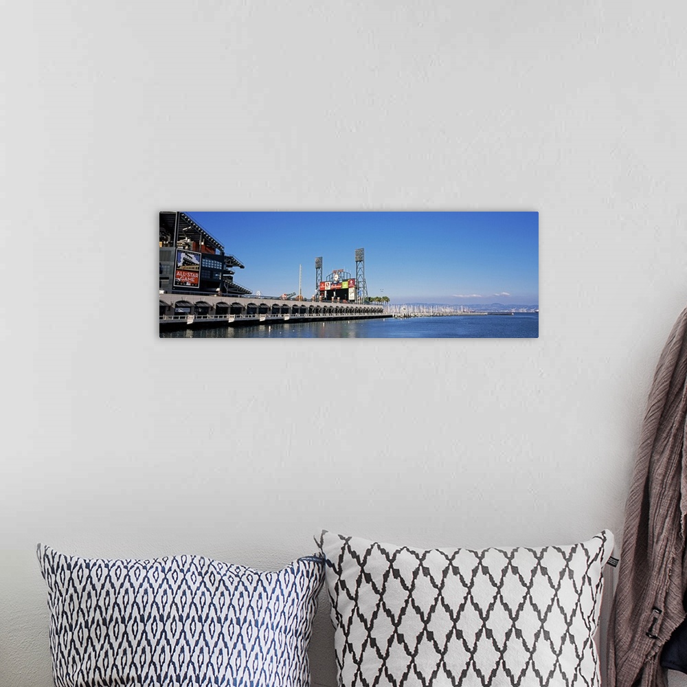 A bohemian room featuring View from the bay of a baseball stadium under a clear blue sky, with the city skyline in the dist...