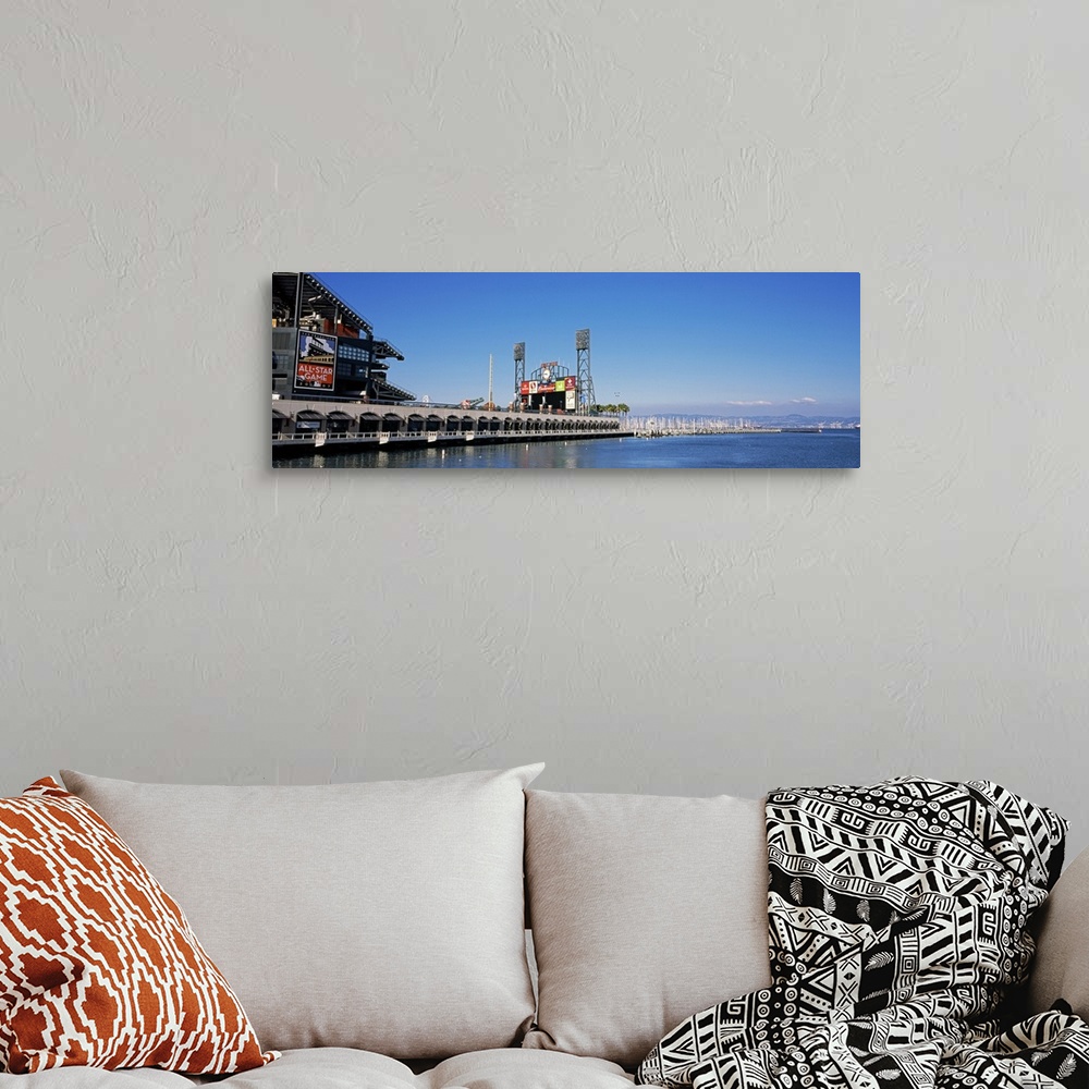 A bohemian room featuring View from the bay of a baseball stadium under a clear blue sky, with the city skyline in the dist...