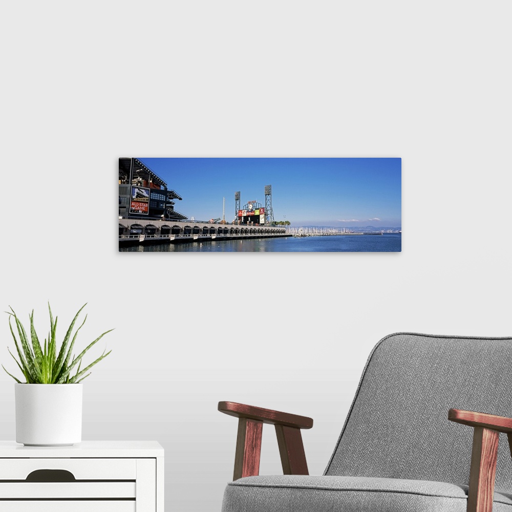 A modern room featuring View from the bay of a baseball stadium under a clear blue sky, with the city skyline in the dist...